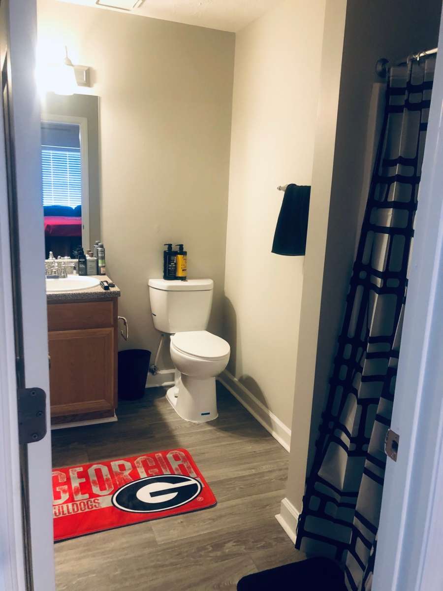 a bathroom with a toilet and a towel