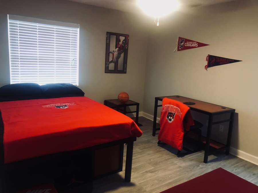 a bedroom with a bed and desk