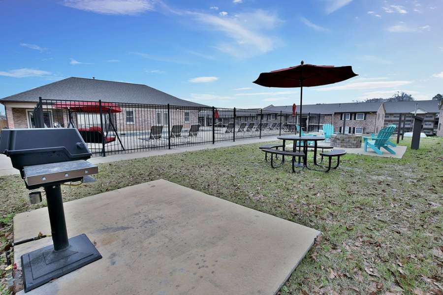 a picnic table and chairs in a yard