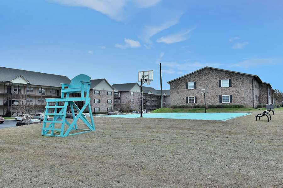 a blue lifeguard chair in a grassy area