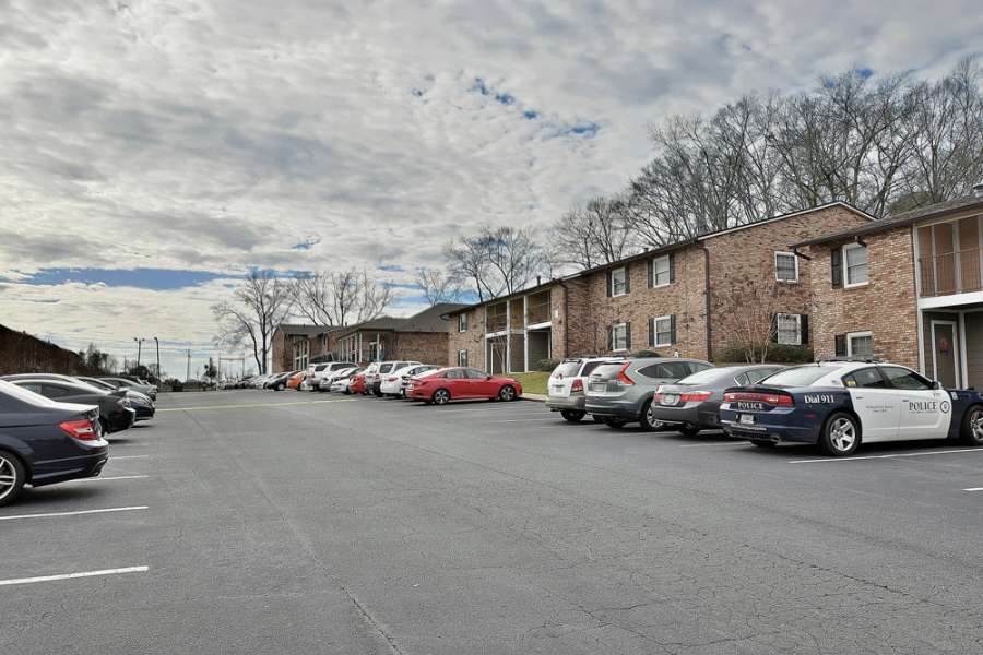 a parking lot with cars parked in front of a building