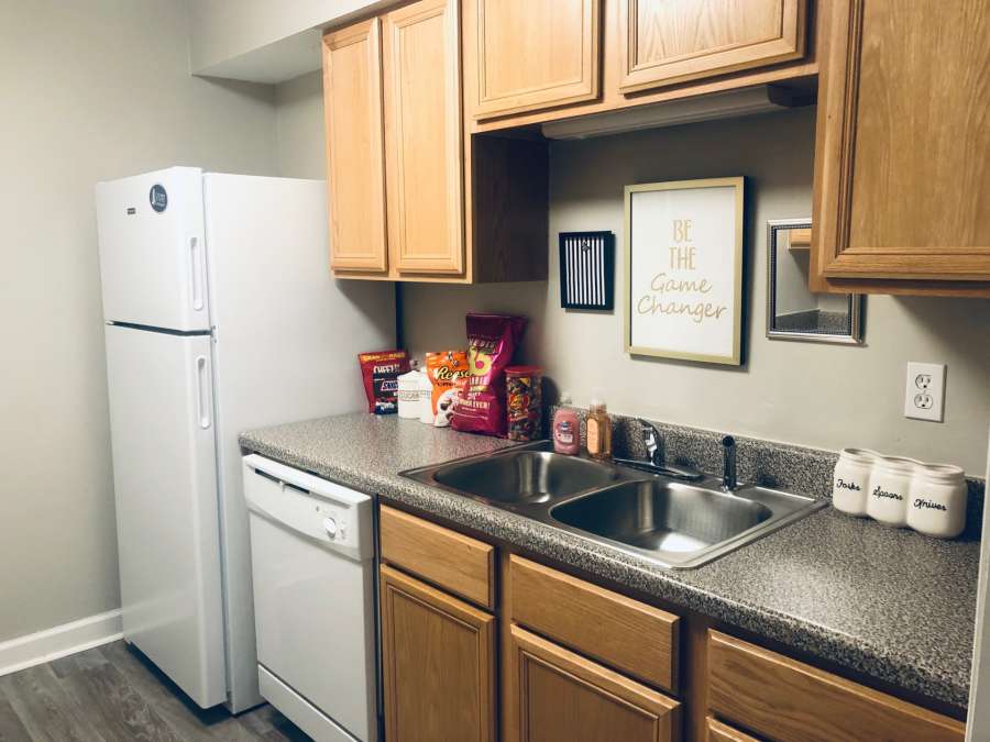 a kitchen with a sink and a refrigerator